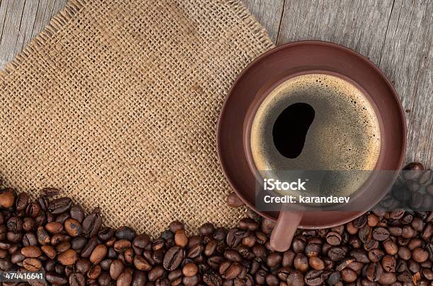 Coffee Cup And Beans On Wooden Table Stock Photo - Download Image Now - Above, Backgrounds, Brown