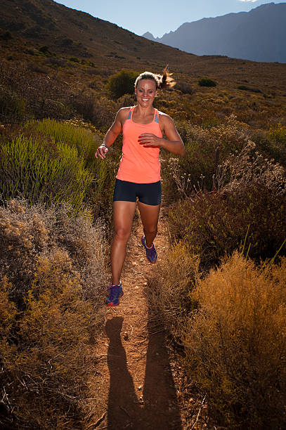 istock Blonde female trail runner running through a mountain landscape 474418936