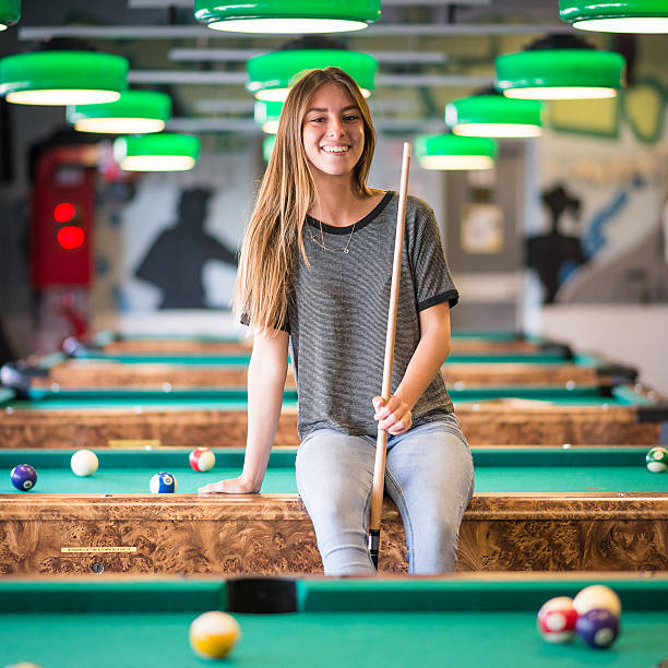 istock Young woman in the pool hall 474419028