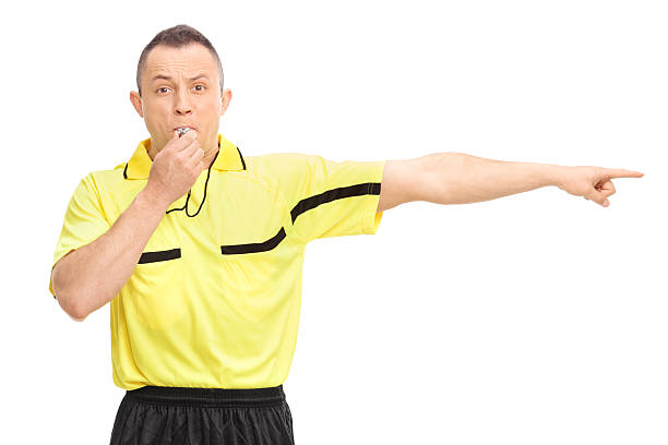 Angry football referee blowing a whistle
