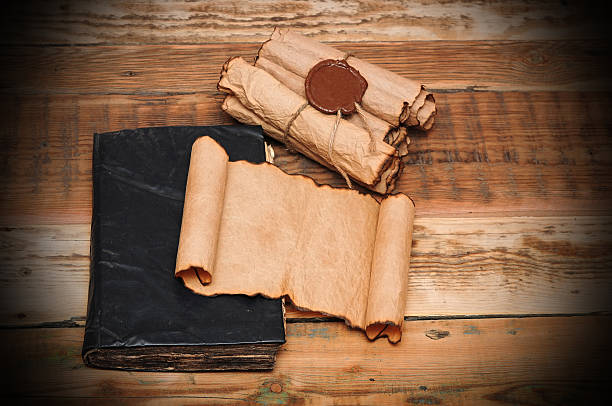 istock Scrolls of vintage paper with old book 474422857