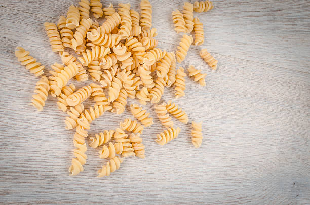 istock White spiral noodles on wooden table 474423432