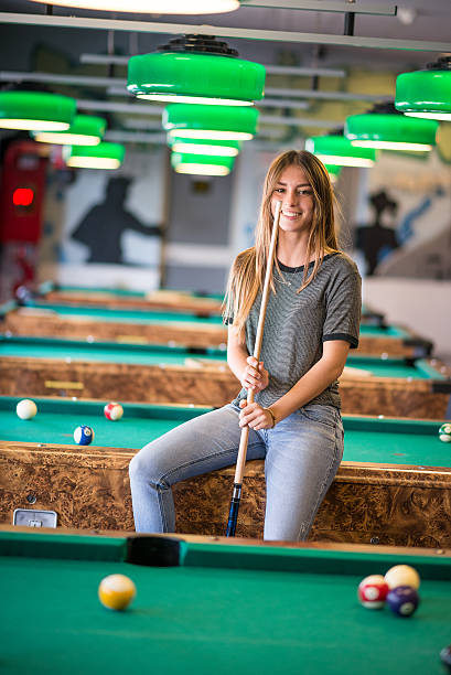 istock Young woman in the pool hall 474423590