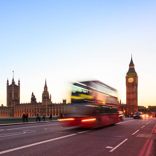 istock London night - Big Ben with blurred double-decker bus 474424445