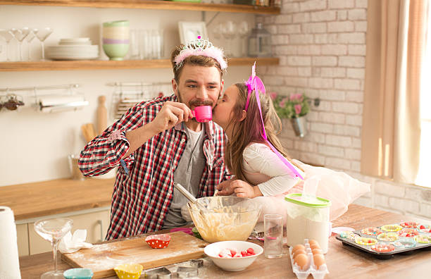 istock Father and daughter baking and having tea party in kitchen. 474427304