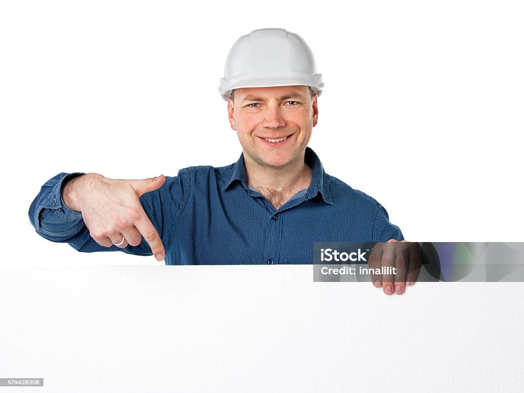 man in a construction helmet a man in a construction helmet holding a white plastic foam and points a finger at him 2015 Stock Photo