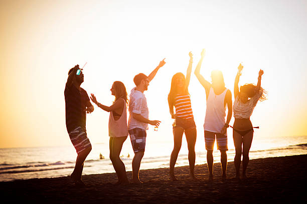 istock Friends dancing at the beach 474428728