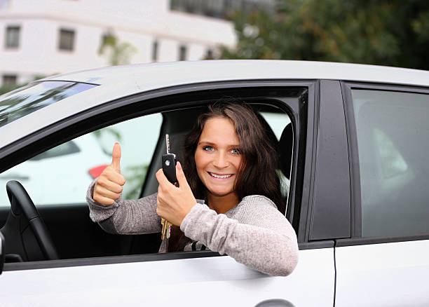 istock attractive young wowan shows her car key 474428783