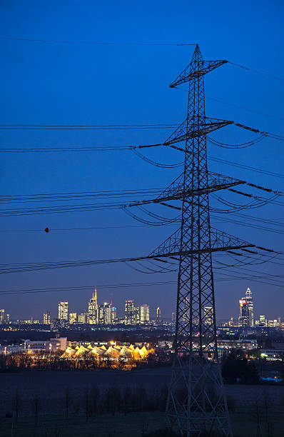 Electricity pylon and Skyline of Frankfurt stock photo