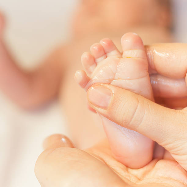istock Mother makes massage for newborn baby 474428816
