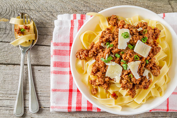 istock Pasta bolognese in white bowl, top view 474428908