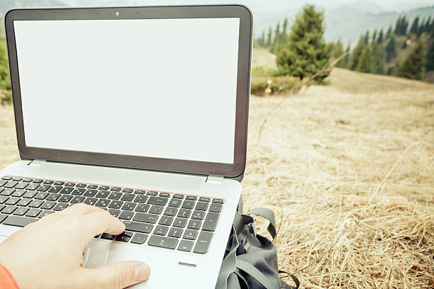 istock tourist uses laptop remotely and relax at mountain 474429190