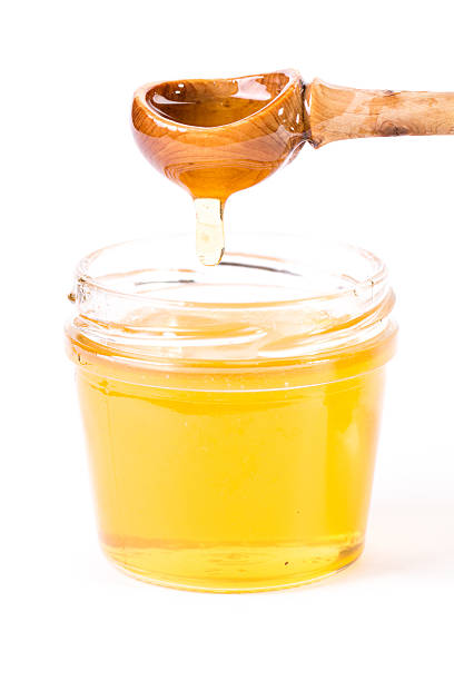 istock Honey dipper on the bee honeycomb background. 474432722
