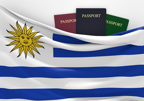 Uruguayan flag and three passports in different colors, representing freedom of travel to and from the country.