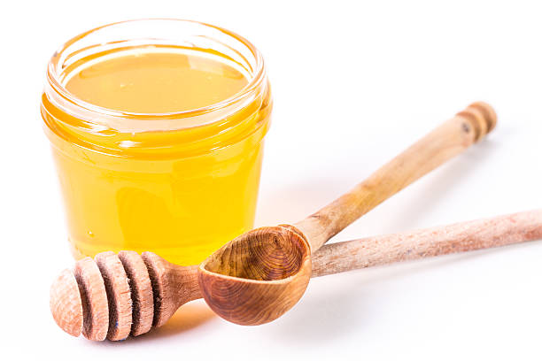 istock Honey dipper on the bee honeycomb background. 474435460