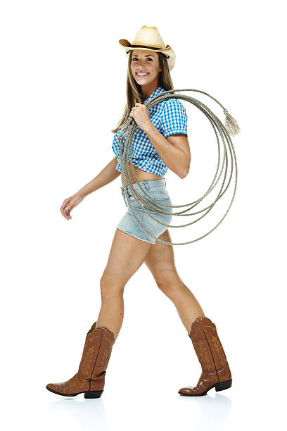 istock Cowgirl walking with lasso 474435546