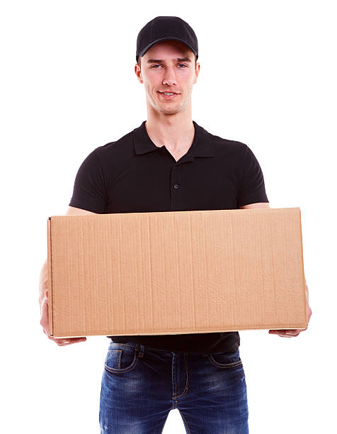 istock Delivery man holding a cardboard box 474436800