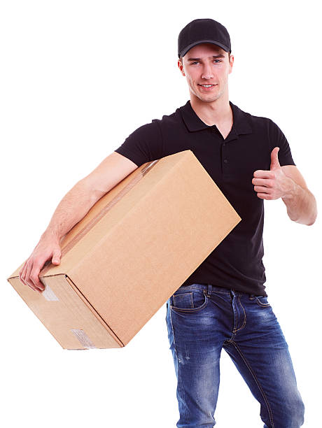istock Delivery man holding a cardboard box 474436838