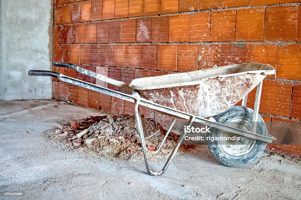 wheelbarrow in workplace wheelbarrow after building a brick wall in a workplace 2015 Stock Photo