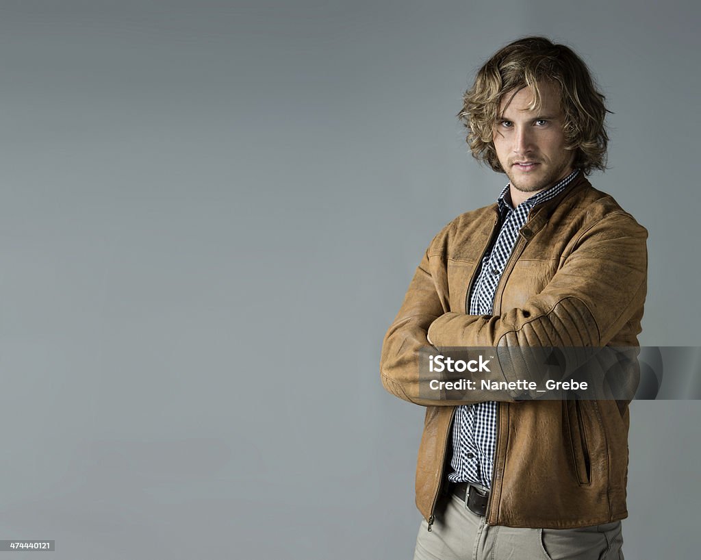 Handsome caucasian man Portrait of a handsome caucasian man wearing a blue checkered button shirt and a leather jacket. Beautiful People Stock Photo