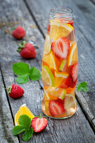 istock Fresh fruit detox water in bottle on wooden table 474440342
