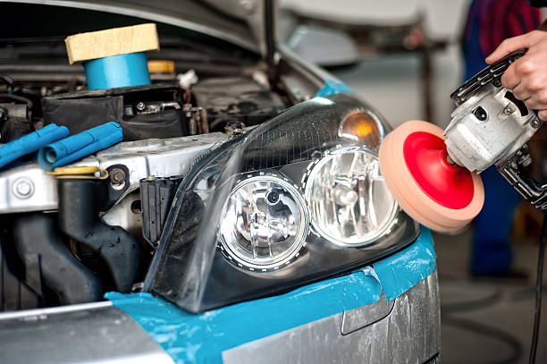 istock auto mechanic working on polishing a car headlights 474441155
