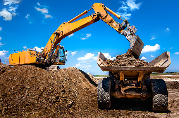 istock Excavator loading dumper truck tipper in sandpit 474442865