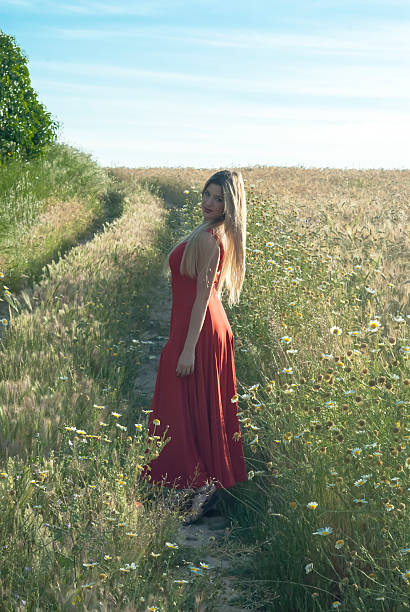 istock Beautiful blond woman in a path into a wheat field 474443328
