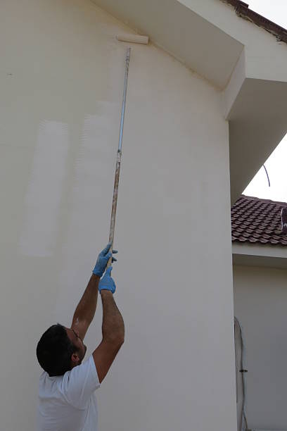 istock Man painting house 474443388