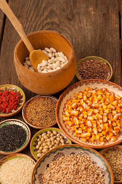 istock Various grain beans in small clay plates on wood background 474443958