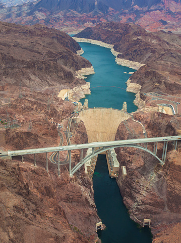 An aerial shot photographed from a Helicopter of the Hoover Dam in Nevada. Hoover Dam, once known as Boulder Dam, is a concrete arch-gravity dam in the Black Canyon of the Colorado River, on the border between the U.S. states of Arizona and Nevada.