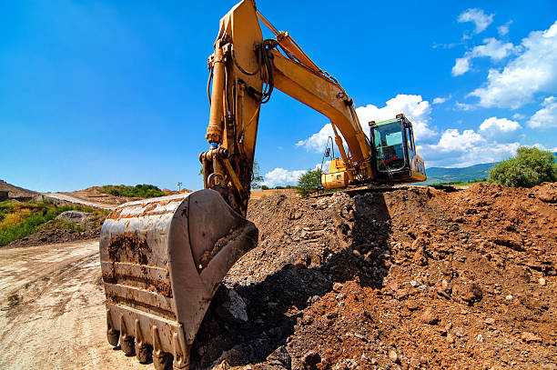 istock Yellow excavator moving soil and sand on construction site 474445071