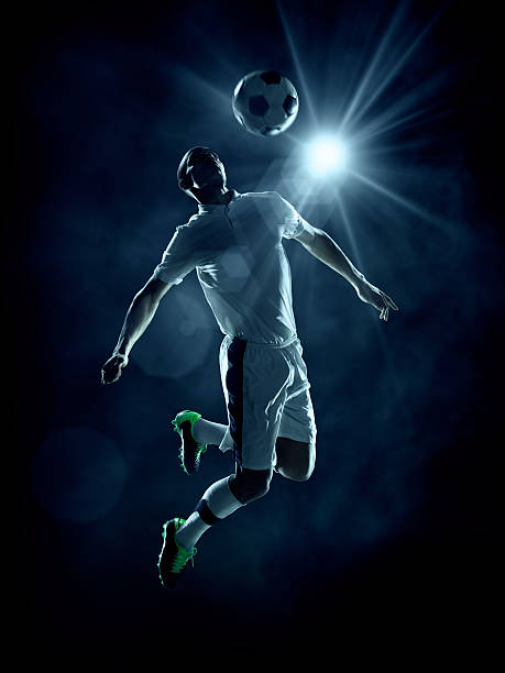 サッカー選手の足蹴りボール - soccer player men flying kicking ストックフォトと画像