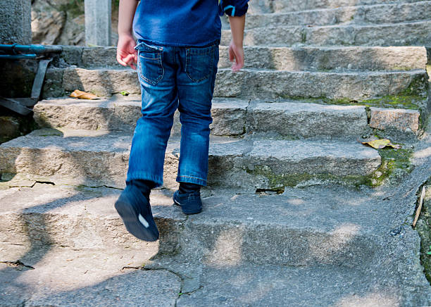 istock Little boy climbing stairs 474447274