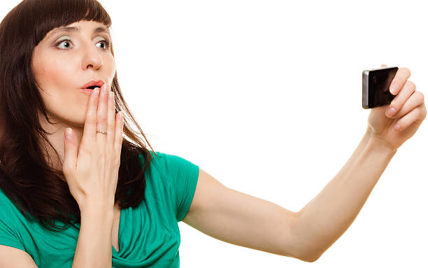 istock Surprised woman reads message on her mobile phone 474448100