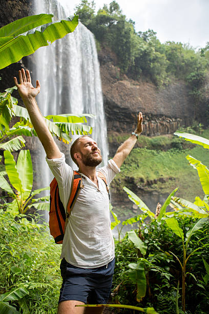 istock Freedom in nature, young man at waterfall 474448526