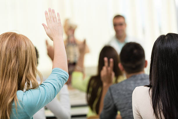 istock Rear view of high school students raising their hands 474448711