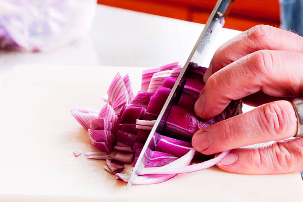 istock Chopping a Red Onion with a Chef's Knife 474450101