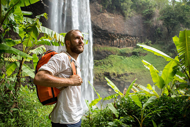 istock Happy young man hiking in jungle-Waterfall 474451254