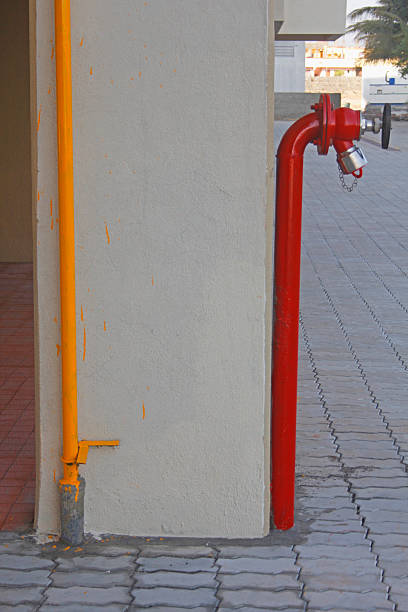 istock Red fire water lines in front of a building 474451559
