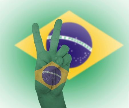 Hand peace sign, wrapped in the flag of Brazil