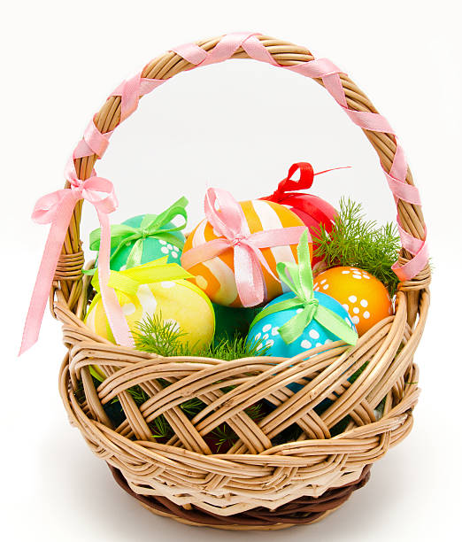 istock Colorful painted easter eggs in basket isolated 474454969