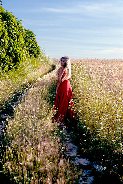 istock Beautiful blond woman in a path into a wheat field 474456494