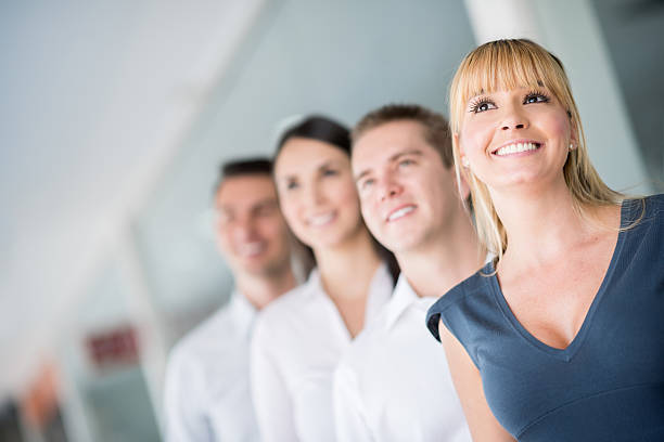 Multiracial group of business people bonding outdoors - International business corporate team wearing elegant suit meeting in a business park