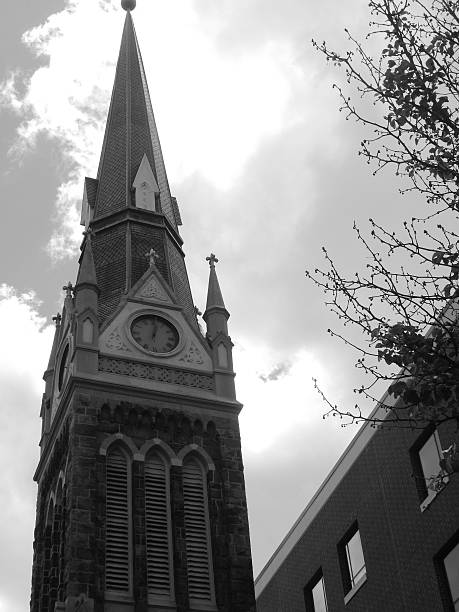 Stone Church Steeple The top of an ornate, stone church steeple can be seen from the sidewalk in the city of Allentown, PA allentown pennsylvania stock pictures, royalty-free photos & images