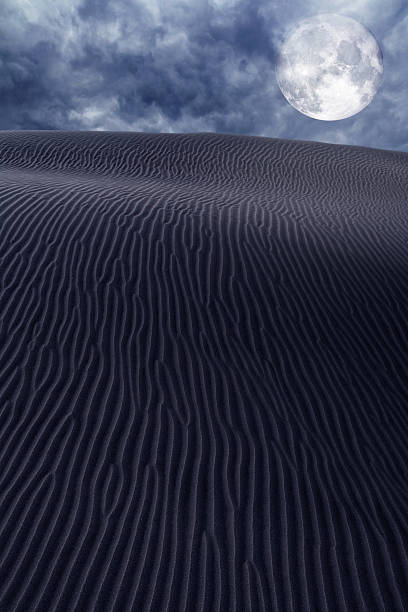 istock Desert dunes sand in moon night sky 474458608