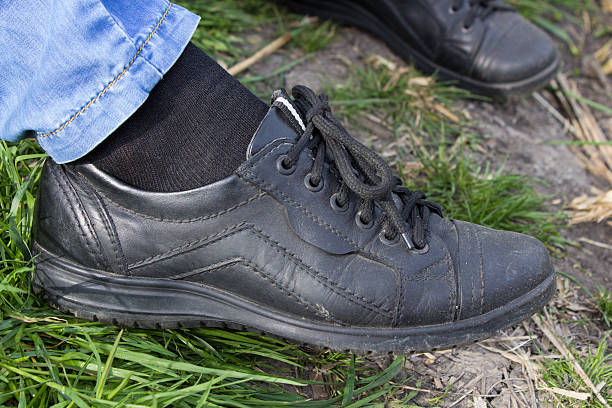 istock black shoes on the leg 474459808
