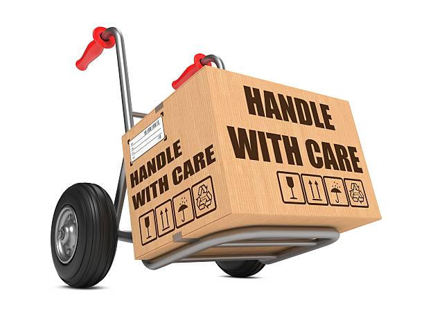 istock Handle with Care - Cardboard Box on Hand Truck. 474459893