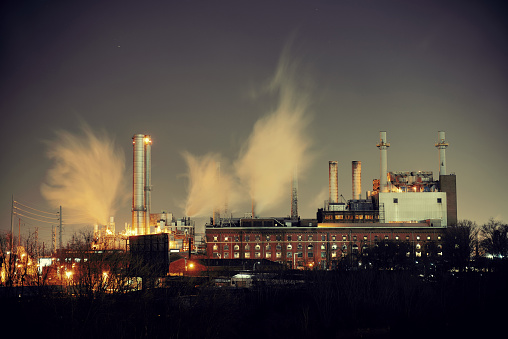 Factory with chimney at night in Philadelphia.