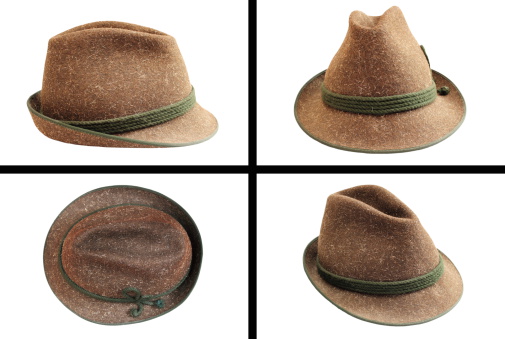 Brown felt trilby hat on a white background.